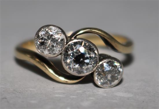 An 18ct gold and three stone diamond ring, size N.